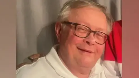 Police handout Headshot image of Stuart Everett smiling and wearing a white polo-neck shirt