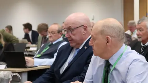 A view of Reform UK council leader Mick Barton at a meeting on 26 February.