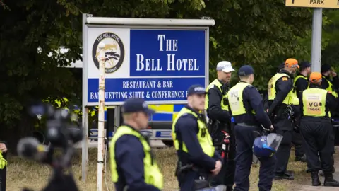 PA Media Police officers ahead of a demonstration outside the former Bell Hotel in Epping