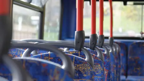 A row of empty bus seats
