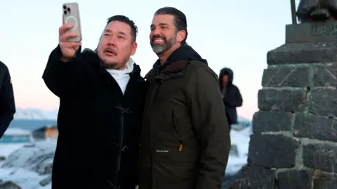 Donald Trump Junior poses for a selfie with a Greenland resident during his visit to Greenland