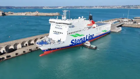 Stena Vinga in Jersey. The ferry is mostly white, with a blue Stena Line logo. It is moored in Jersey harbour. 
