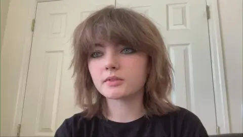 Rebecca Young - a teenager with a dark top on and brunette hair