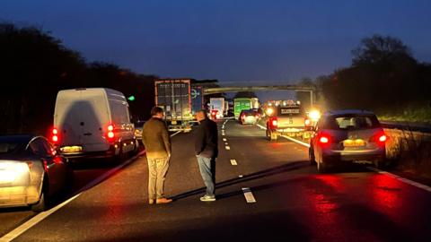 Crash scene on the M50 with drivers out of their cars standing on the road