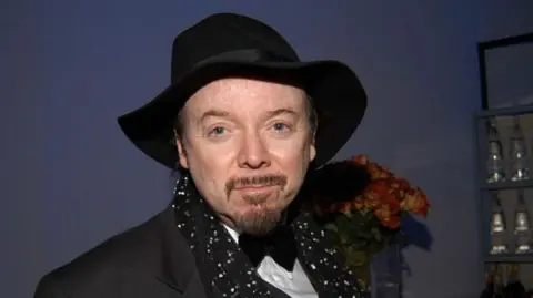 Getty Images Bud Cort wearing a black hat and black suit