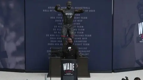 Getty Images Wade in front of his statue