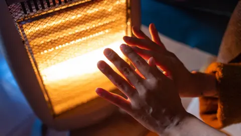 Getty Images Hands opened up to face a space heather which is glowing.