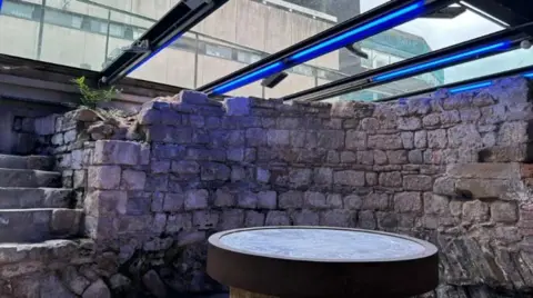 BBC Eastgate Chamber in Gloucester - a roman wall under glass viewing panels