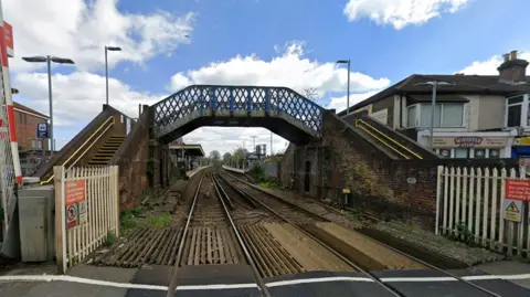 Google Street View looking down the tracks at Cosham Rail Station from the railway level crossing