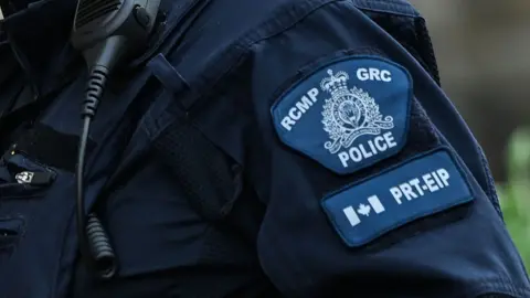 A generic style image of a patch on the arm of a police officer saying 'RCMP GRC'