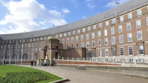 An external shot of City Hall in Bristol with the grass of College Green visible in the foreground