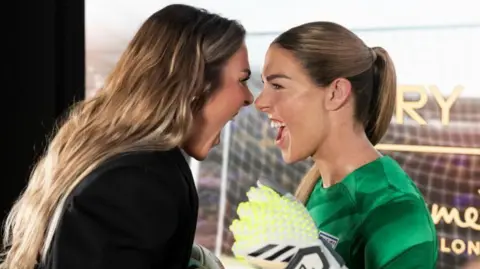 Kirra Young Mary Earps and her waxwork. Earps is head-to-head with it mimicking a shout with her mouth open.