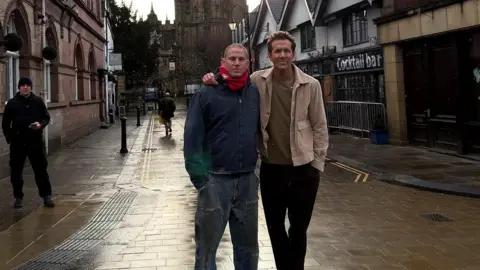 Channing Tatum/Instagram Channing Tatum and Ryan Reynolds pictured in the street smiling at the camera. Tatum wears jeans, a denim jacket and a red scarf and Reynolds wears a beige jacket over a brown jumper and dark trousers