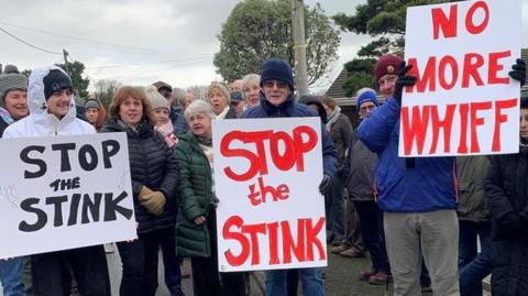 Withyhedge Landfill protestors with signs saying Stop the Stink and No More Whiff.
