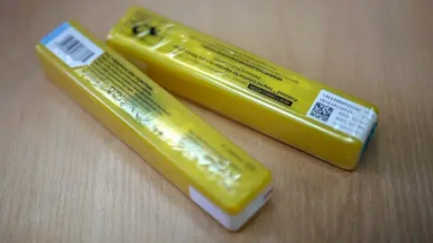 BBC Two yellow packets of naloxone , which look similar to sweet packets.