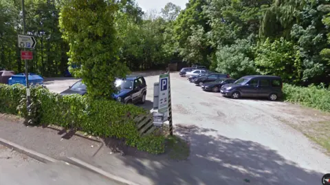 Car park surrounded by trees