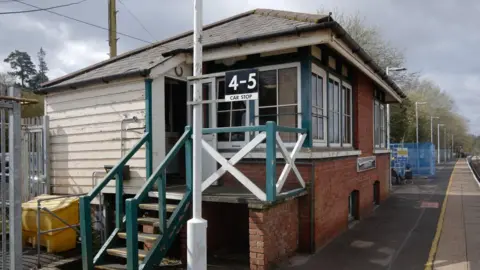 Haslemere Signal Box Trust A brick building next to a railway platform