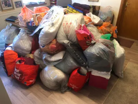 John Davies pile of donations in plastic bags 