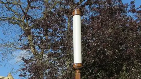 Hugh Venables/GEOGRAPH Top of a lamp in Cambridge. It has a tubular design and is tall and slim