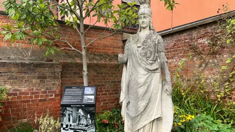 The statue of the Roman goddess of wisdom Minerva which was on the front of the bombed out building in Albion Street it now stands next to a plaque in Hull Museum Gardens