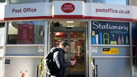 Getty Images A man walks past a Post Office branch