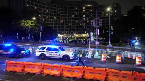 Reuters Police cards and barricades in front of the Washington Hilton hotel