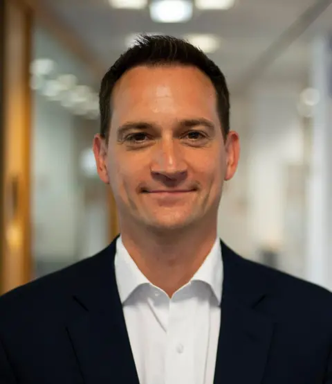 SUPPLIED Henry Gregg, chief executive of the National Pharmacy Association, wearing a black jacket and white shirt. 