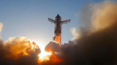 A SpaceX Super Heavy booster carrying the Starship spacecraft lifts off during a test flight at the company's launch pad in Starbase, Texas
