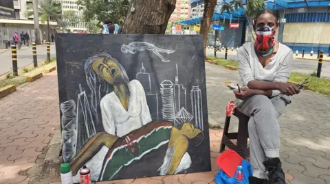 BBC/Mercy Juma An artist with her artwork depicting a protester who was shot dead by police