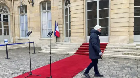 Anne RENAUT/AFP A red carpet appears outside the prime minister's residence at Hotel Matignon in the centre of Paris.