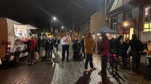 Newbury Soup Kitchen A crowd of people outside queueing for food