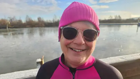 An image of Bridget Betts wearing a hat and swim suit at Spring Lakes