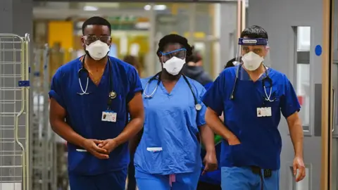 PA Media File photo dated 21/12/21 of medical staff wearing FFP3 face masks at King's College Hospital, in south east London.