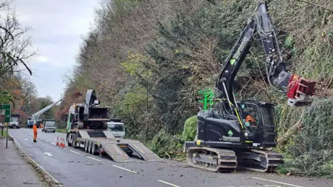 Derbyshire County Council Vehicles cutting trees along the A6 in Derbyshire between the junction at Cromford and Matlock Bath. The road is closed to traffic.