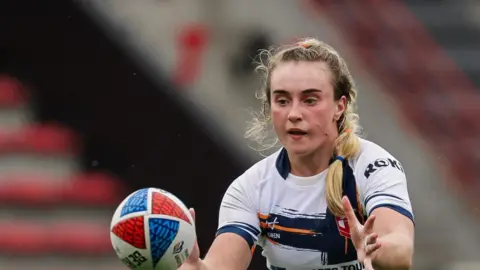 Paige Travis in action for England against France in 2024