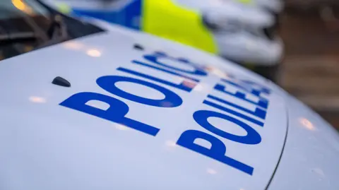 Close up of a line of police vehicles