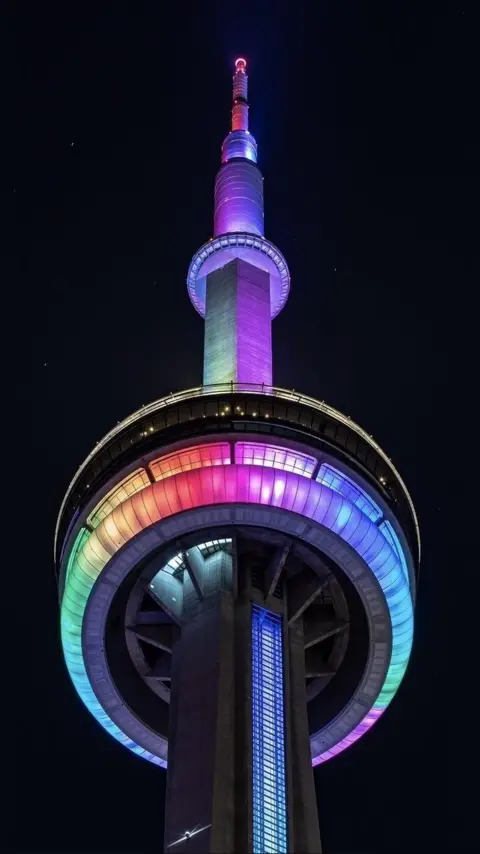 Dave Smith The CN Tower, captured from underneath, lit up in rainbow colours for the AHC awareness campaign