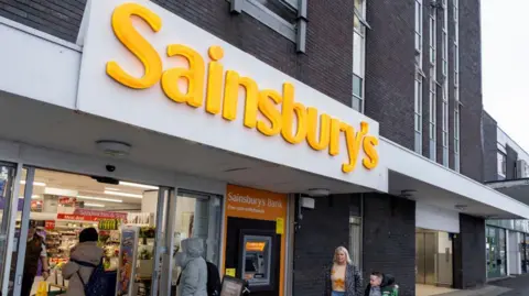 Getty Images People walking into a Sainsbury's supermarket