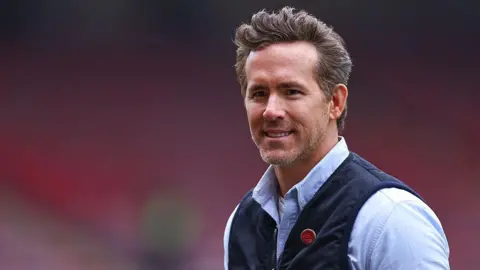 Getty Images Ryan Reynolds ahead of the Emirates FA Cup Fifth Round match between Wrexham and Chelsea at Racecourse Ground on March 7, 2026 in Wrexham, Wales. (Photo by Robbie Jay Barratt - AMA/Getty Images)
