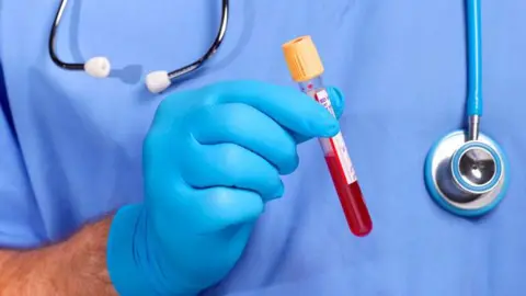 Getty Images Doctor holding blood in test tube