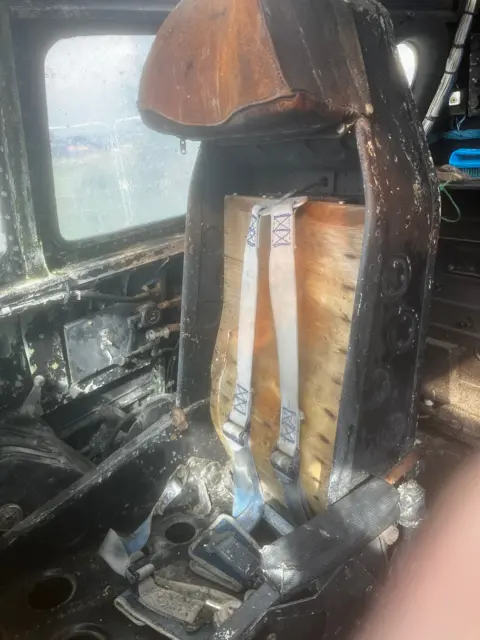 The cockpit is made of leather and metal and is in a state of disrepair.