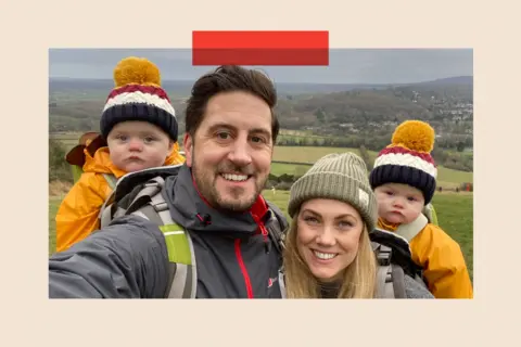 Shaun walking with his partner and two small children in matching bobble hats