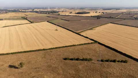 An overhead shot showing a patchwork of brown, dried out fields in Northamptonshire.