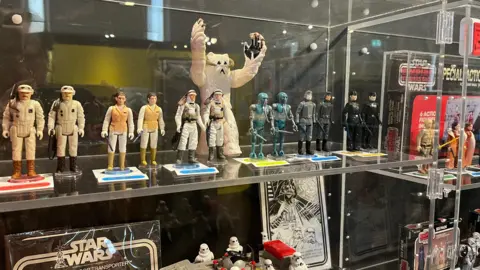 A museum case containing lots of small figures of Star Wars characters on show at Lynn Museum.