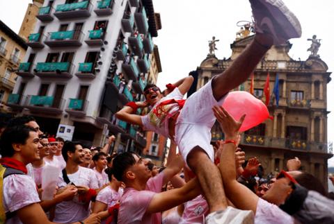 A person crowd surfing at the San Fermin festival