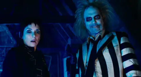 Warner Bros Winona Ryder and Michael Keaton looking surprised in Beetlejuice Beetlejuice