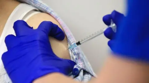 Getty Images person gets a Covid vaccination