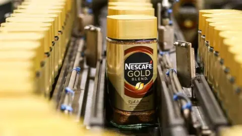 Getty Images Nescafe gold jar on production line