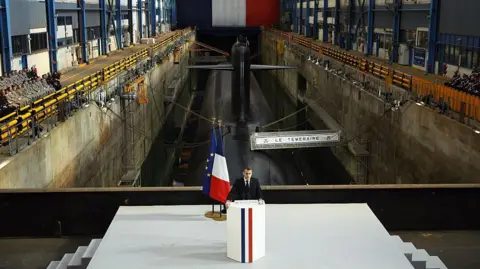 Getty Images Macron standing in front of a French nuclear attack submarine