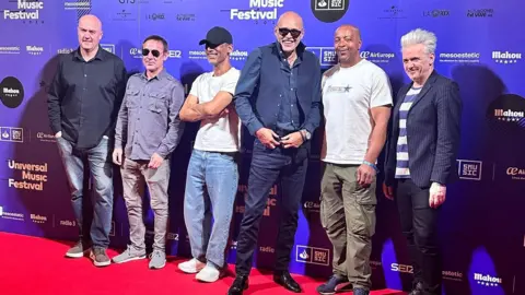 The Christians/Emma Roberts The Christians' bandmates stand together at an event in Madrid